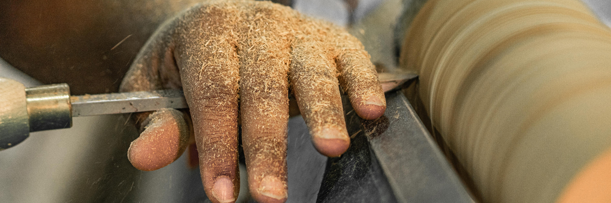 SCDJJ youth turning wood on a lathe